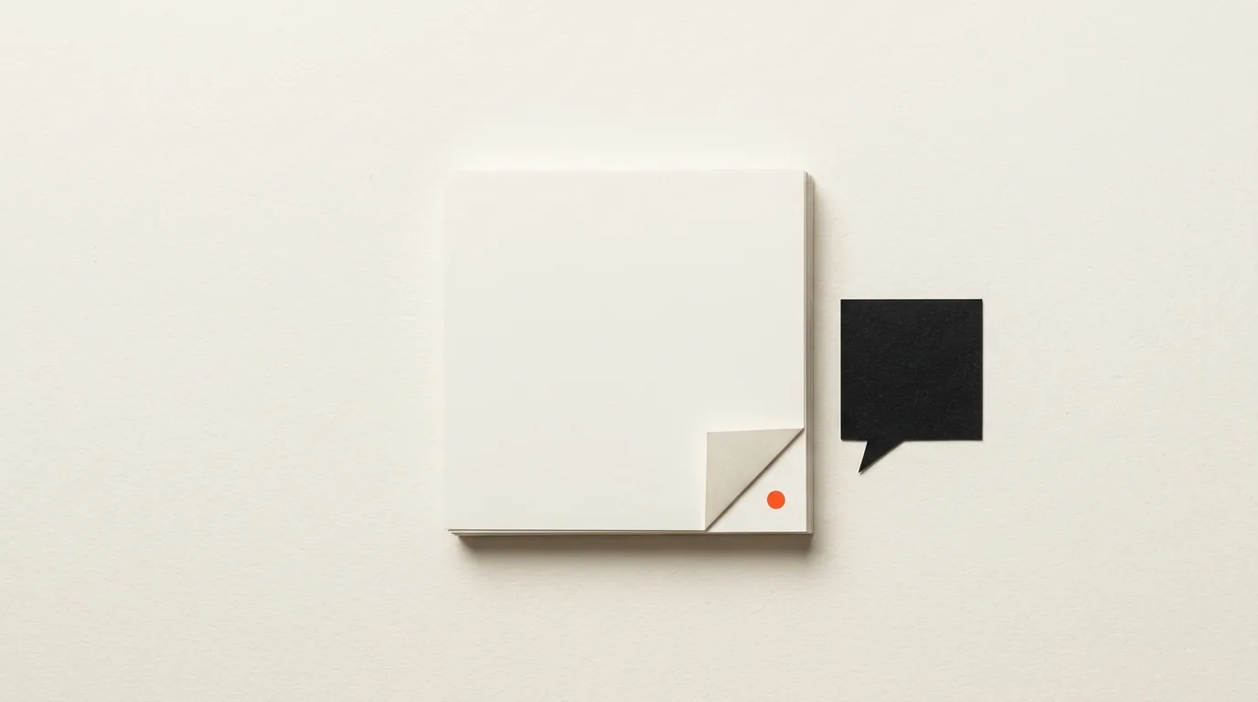 Cut-paper illustration: a stack of blank document pages with a folded corner beside a small paper speech bubble, in black and off-white with one red-orange accent