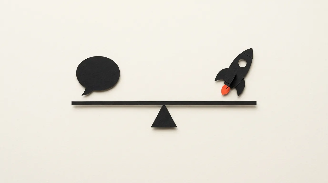 Cut-paper illustration: a paper speech bubble and a small paper rocket balanced on a paper seesaw, in black and off-white with one red-orange accent